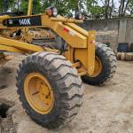 Used excavator land leveller Caterpillar CAT140K roader machine secondhand japan