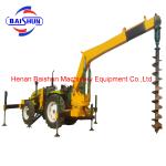 Wooden pole erecting by tractor mounted post hole digger machine