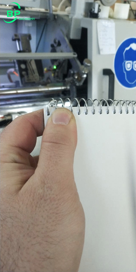 Spiral notebook coil lock