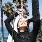 Girl taking a shower with the Kradl portable camp shower