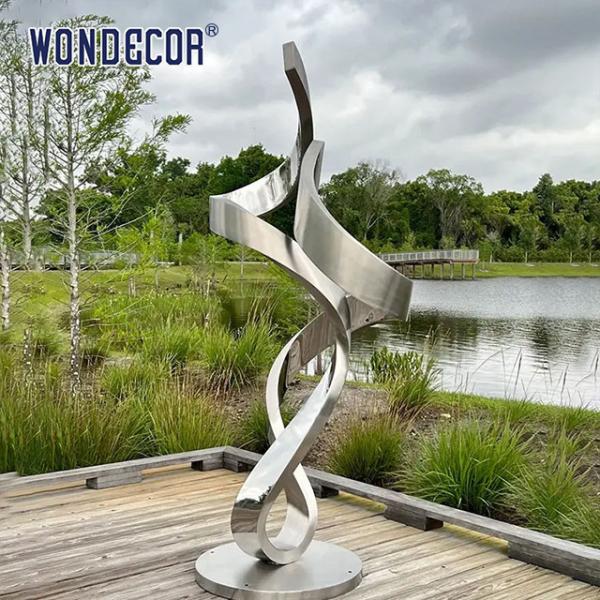 Large forged metal shaped twisted geometric stainless steel sculpture in the