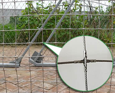 A piece of installed stainless steel square rope mesh with cross-shaped ferrules.
