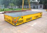 Battery operated steerable motorized trackless transfer car on cement floor