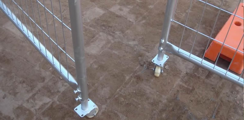 The opening temporary fence gate is installed two white rubber wheels.