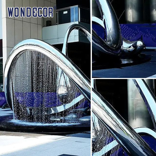 Large geometric circular fountain stainless steel sculpture in the square